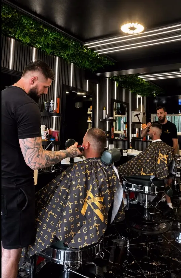 Barber working a fade with clippers at Royal Fade Studio