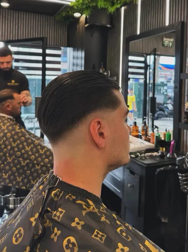 Low taper fade with a slicked back top